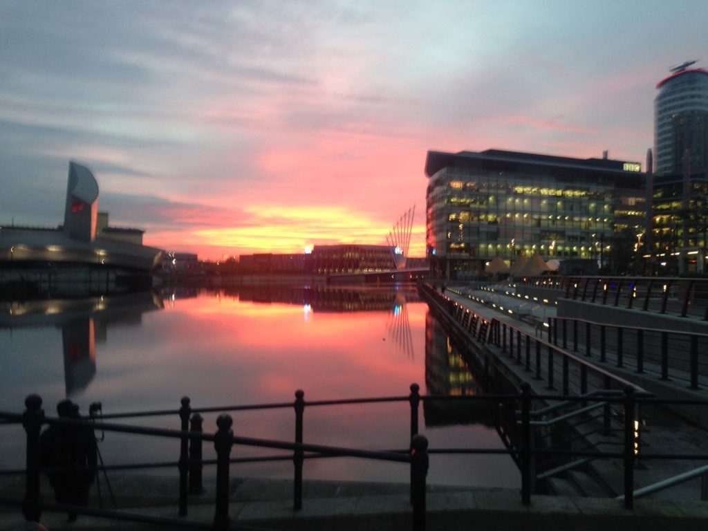 Image: this is a photograph of the sun setting in Salford Quays.