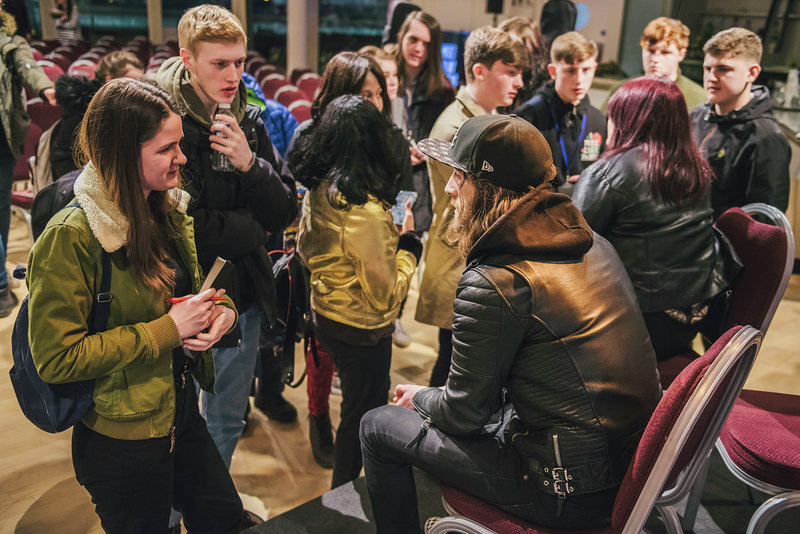 Image: School students interacting with Blossoms tour manager Dan Woolfie