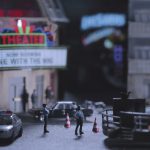 A small model of a cinema with police officer figures outside.