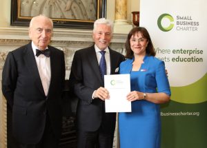 Professor Amanda Broderick receives the Small Business Charter Award from Sir Peter Bonfield (centre) and Lord Young