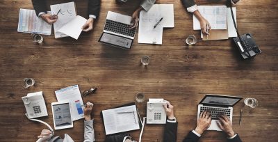 Aerial view of a desk with a team working