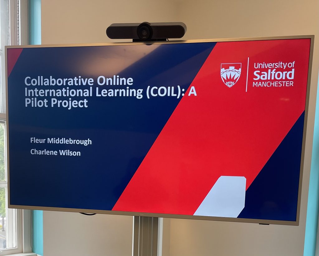 Widen participation presentation on a projector. The presentation has a dark blue background and a red stripe.