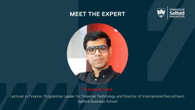 A photo Dr Zeeshan Syed posing towards the camera in the middle of a dark blue background graphic