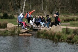 Group of litter pickers by a lake in the park