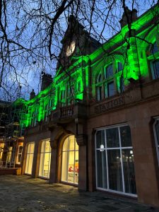 The old fire station at night lit up with green lights