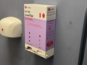 A period product dispenser on a wall