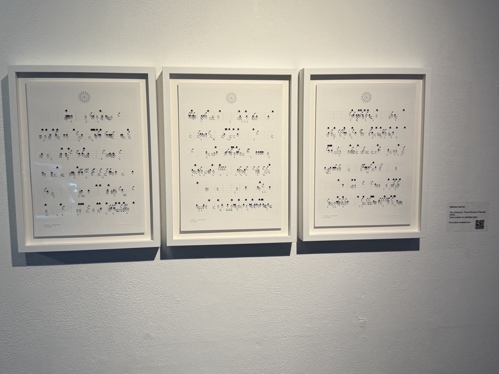An image of three framed prints of a musical score