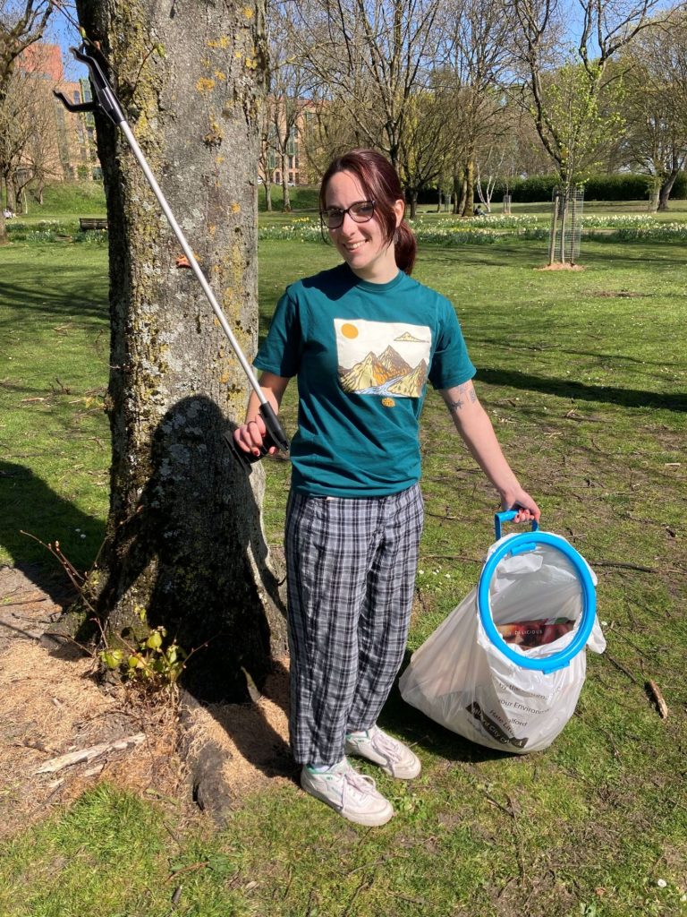 Someone litter picking in a park
