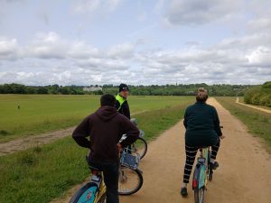 Three people on bicycles looking at the view at Kersal Wetlands.
