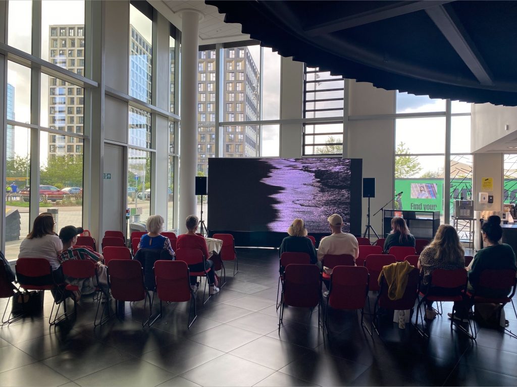 People sitting watching the film ALBATROSS on the Ground Floor of MediaCity Campus