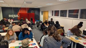 Poeople sat in a classrom doing group work about the Sustainable Development Goals.
