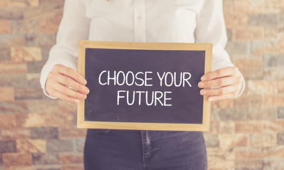 Woman holding black board showing choose the future
