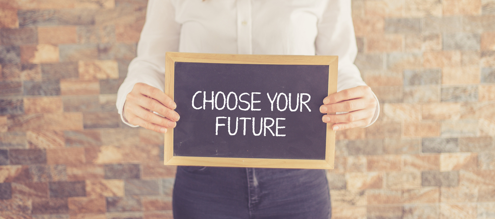 Woman holding black board showing choose the future