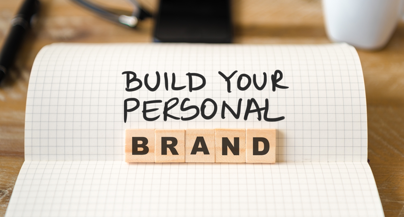 Ruled book and blocks saying building your personal brand