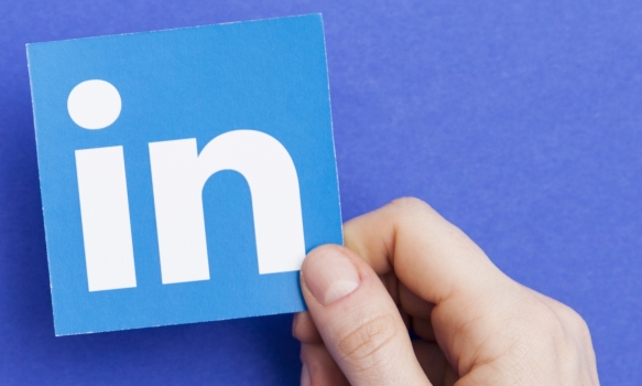 Hand holding the LinkedIn icon