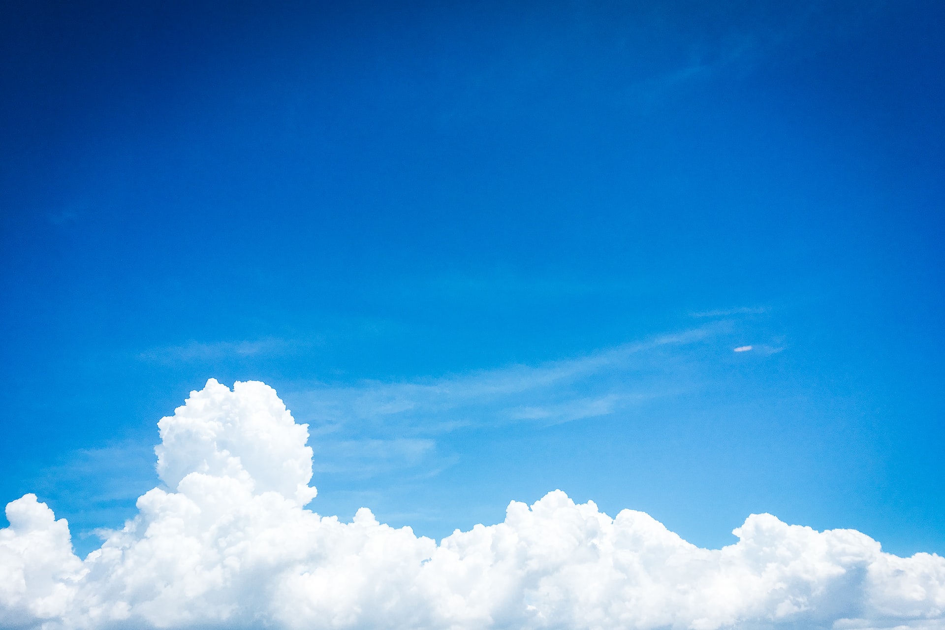 A blue sky with white fluffy clouds