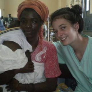 Female nursing graduate, Jemma Berwick, poses for a photograph with a baby patient and the baby's mother in a hospital