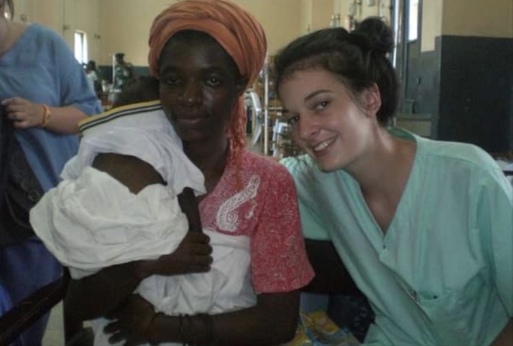 Female nursing graduate, Jemma Berwick, poses for a photograph with a baby patient and the baby's mother in a hospital
