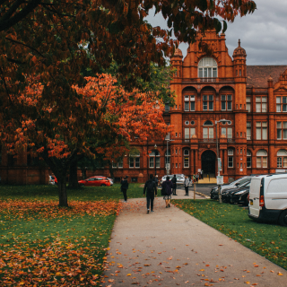 An inspiring photo of the Red brick Peel building and greenery in front