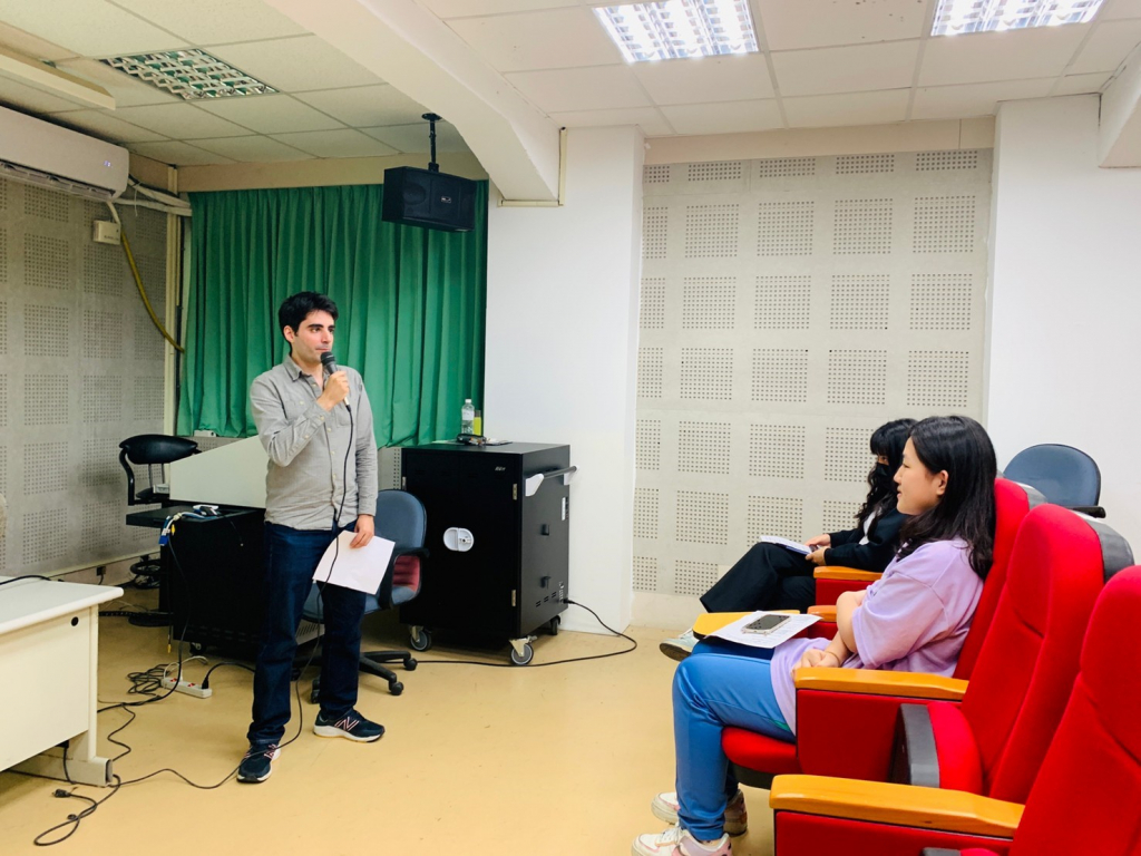 Mischa speaking to students in a small lecture hall