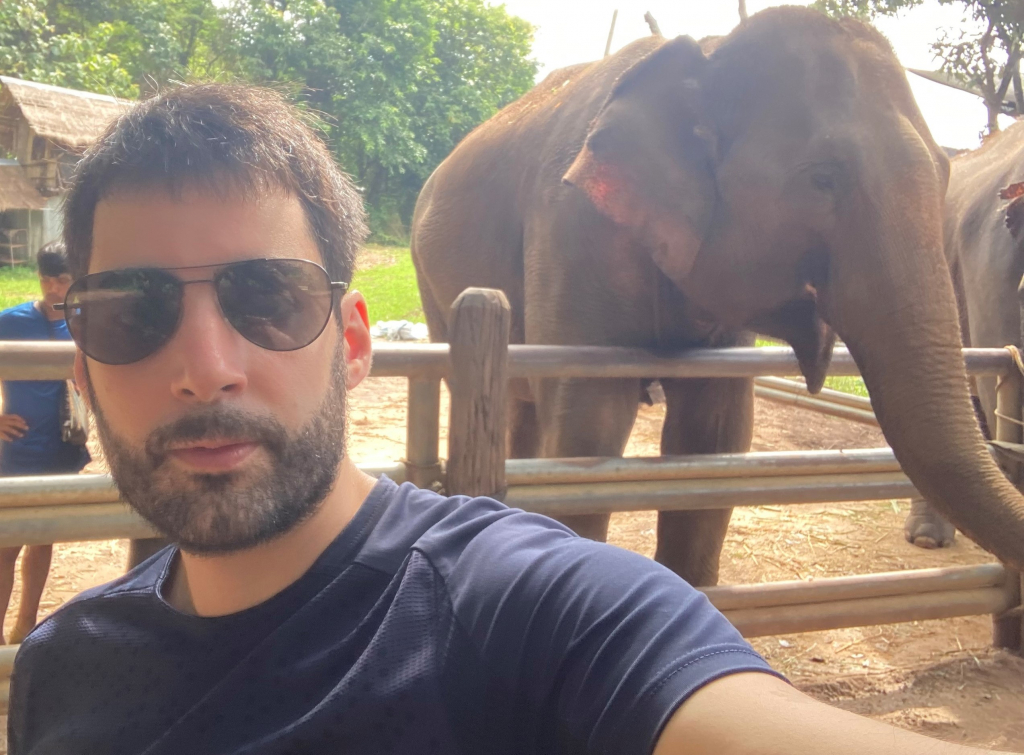 Mischa taking a selfie with an elephant on his travels