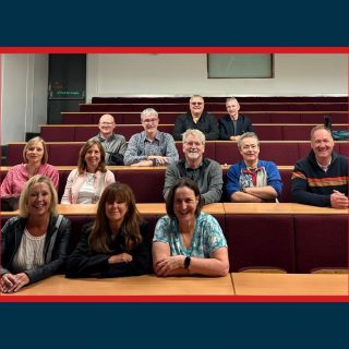 Alumni in a lecture theatre after 40 years.