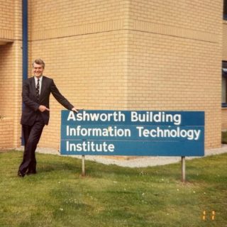 Sir John Ashworth outside the Ashworth building on campus, 1991