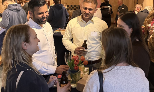 A group of alumni networking at the social event