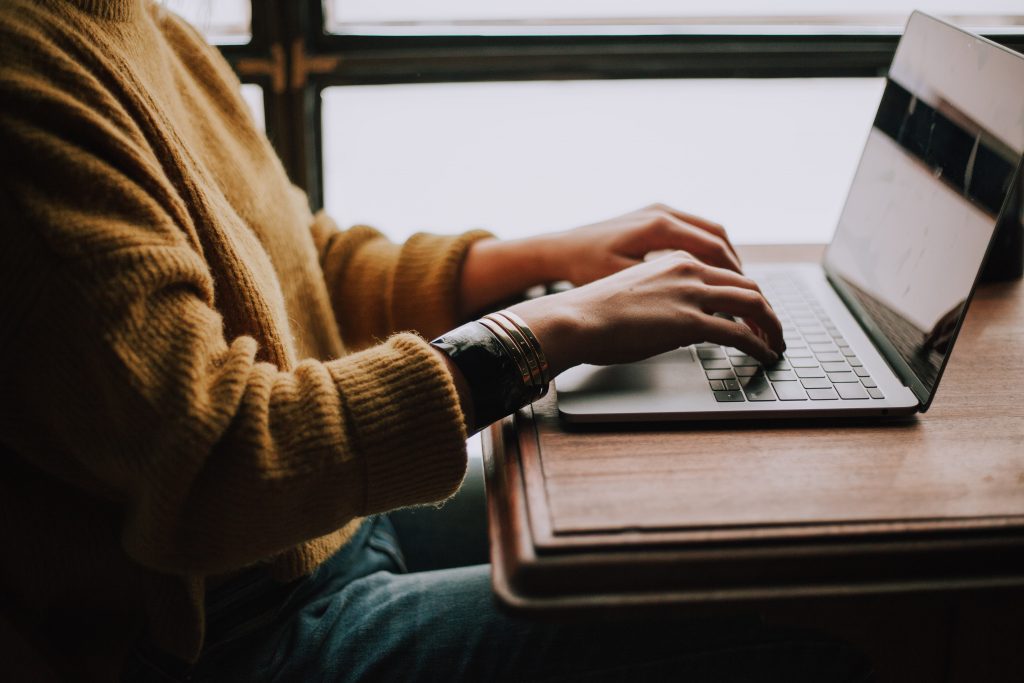 Person typing on a laptop, representing the disability laptops students can access