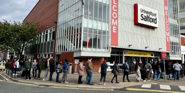 Students queue for a Careers Fair.