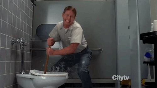 Guy plunging a blocked toilet