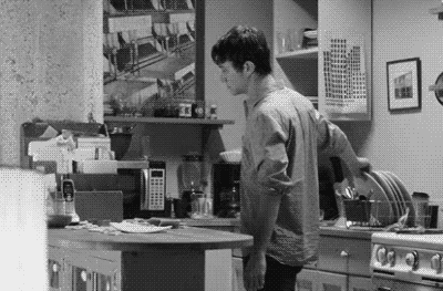 black and white scene of a guy smashing a plate on a worktop
