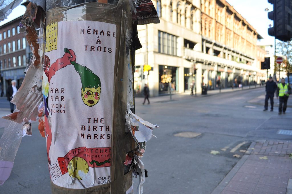 Colourful flyers on a lamp post on Oldham Street