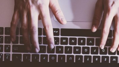 Man typing on laptop