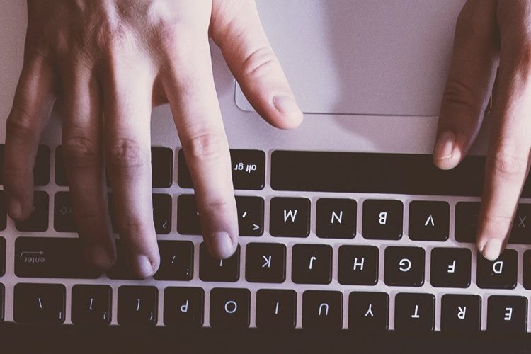 Man typing on laptop