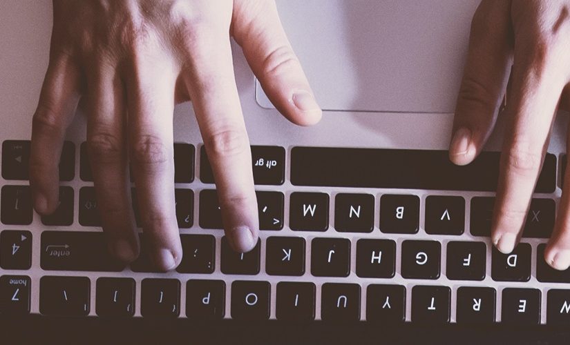 Man typing on laptop