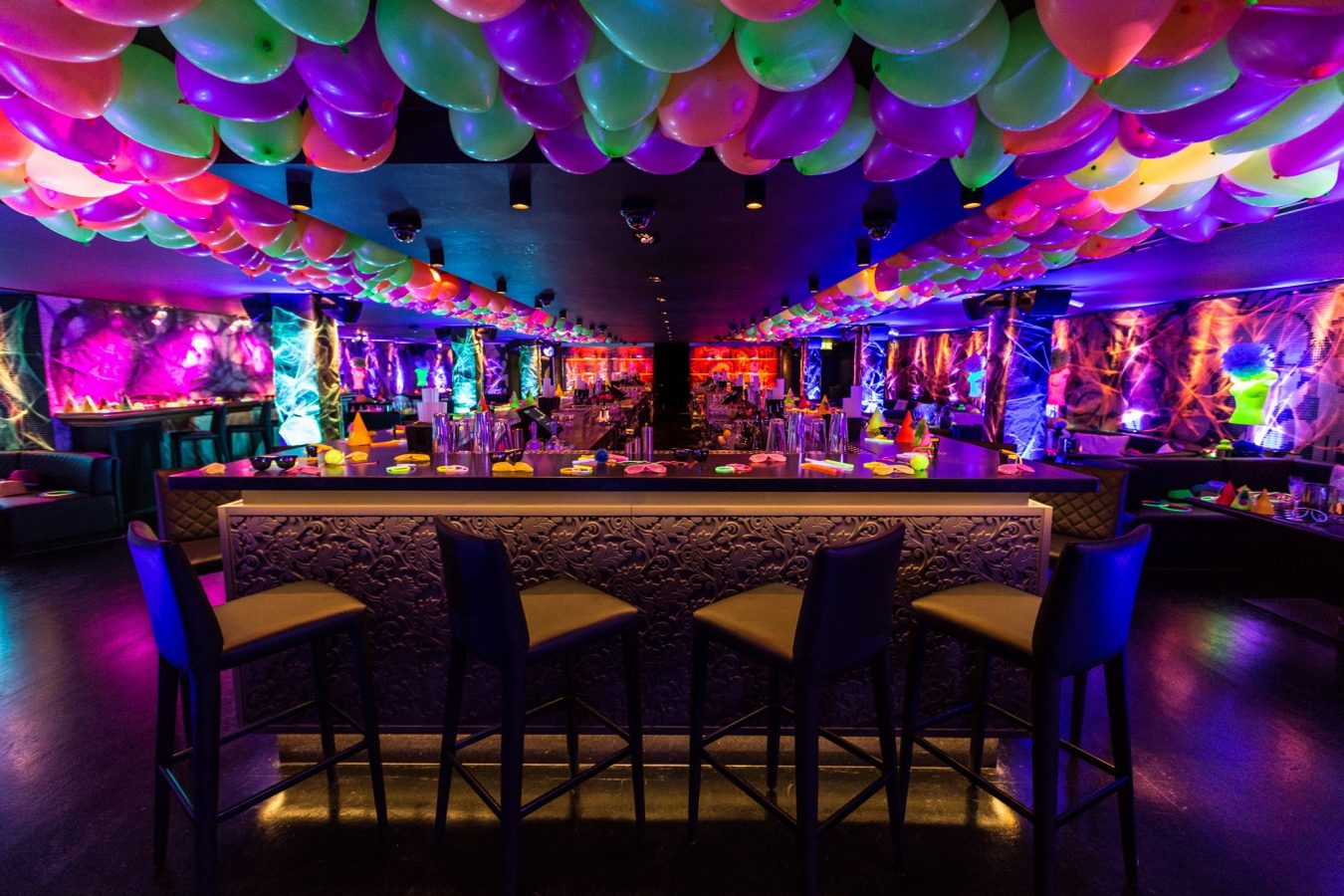 Inside Panacea showing lot of balloons on the ceiling and the bar in the middle