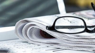 Laptop and newspaper