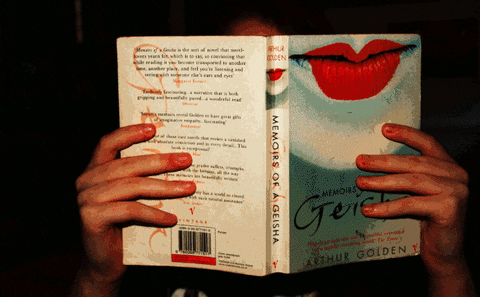 someone holding up a book reading and the cover is changing between many books