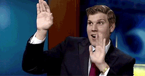 Man doing silly dance with hands up in front of him in the air