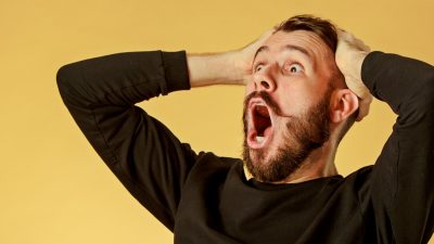 image: man holding head with hands shocked and excited