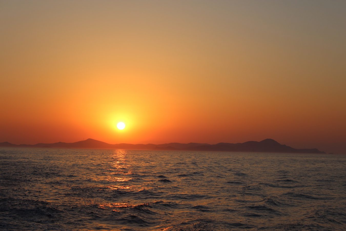 Sunset over the island if Lipsi taken from a boat on the sea