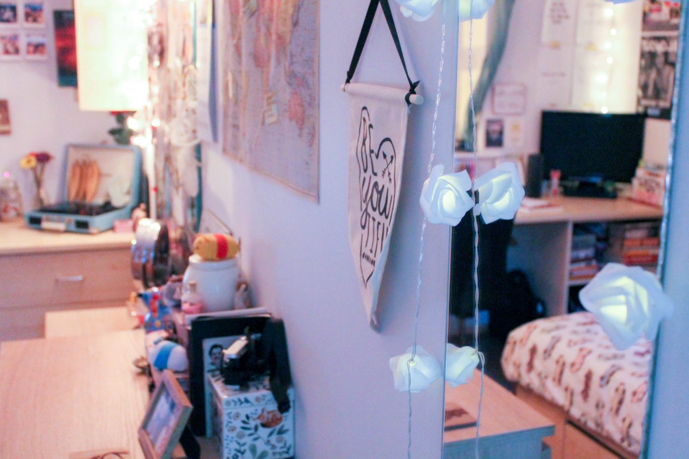 A mirror, a map, and photos in Seren's bedroom