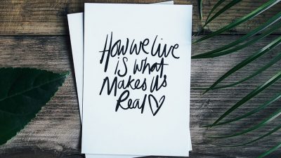 Image: Card with "How we live is what makes us real" text