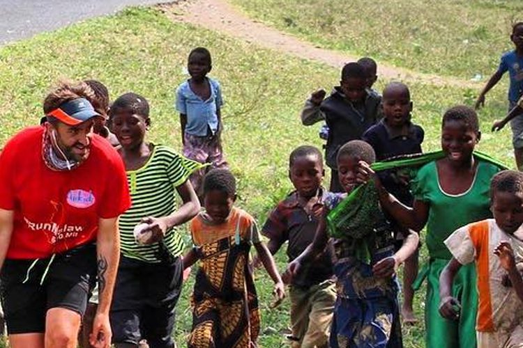 Image: Brendan running accompanied by children