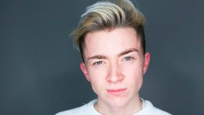 A Photo of Oliver standing in front of a plain background
