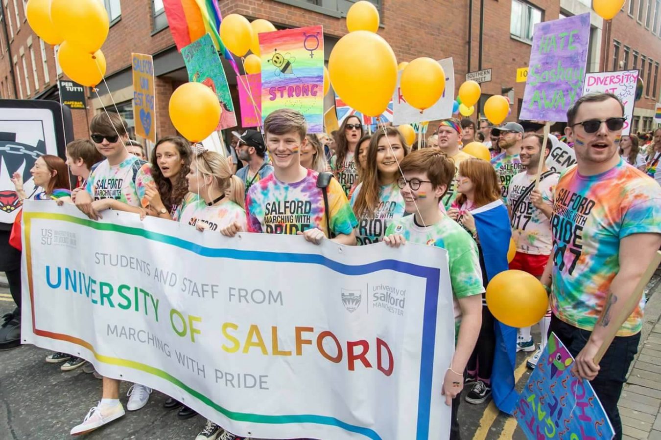Jon-Connor marching at Manchester pride parade with other students