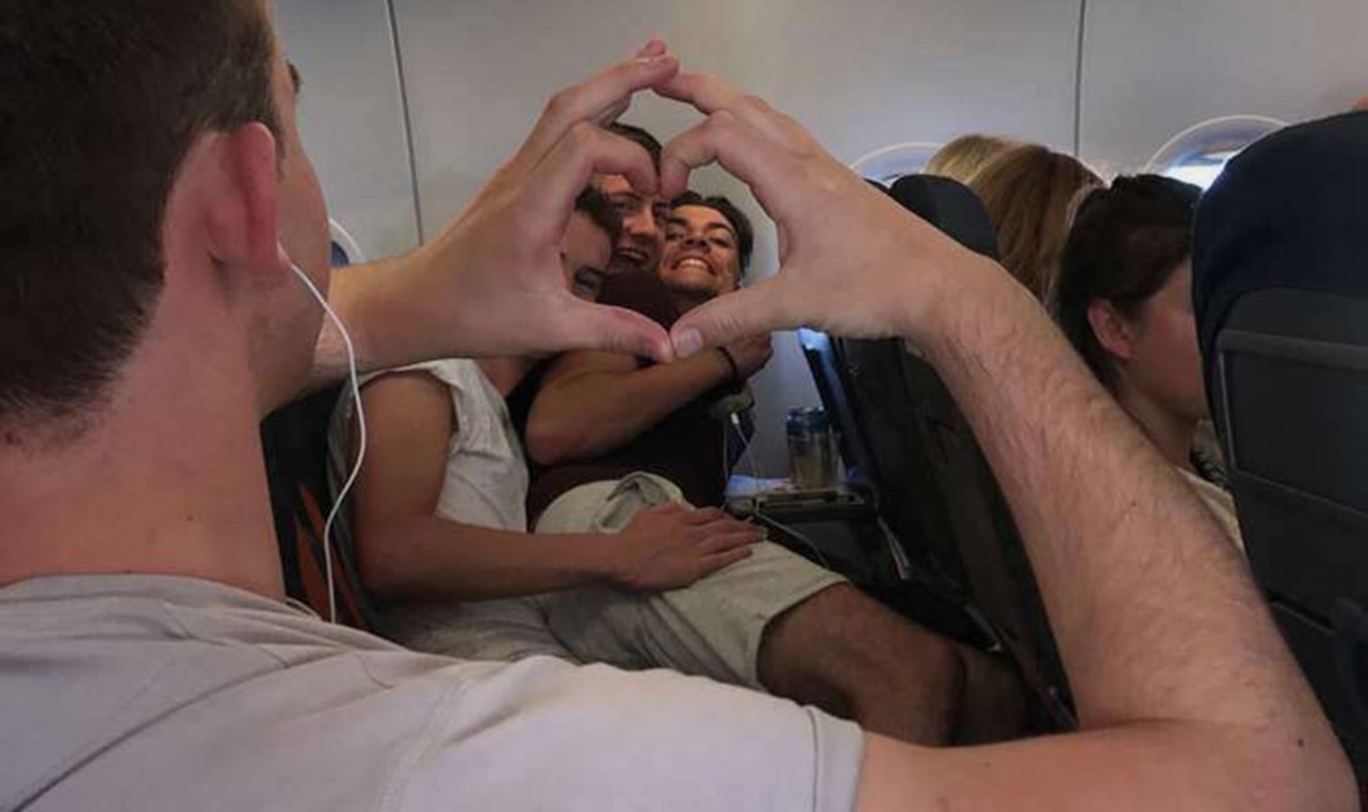 Rhys and his friends on the plane posing for a photo