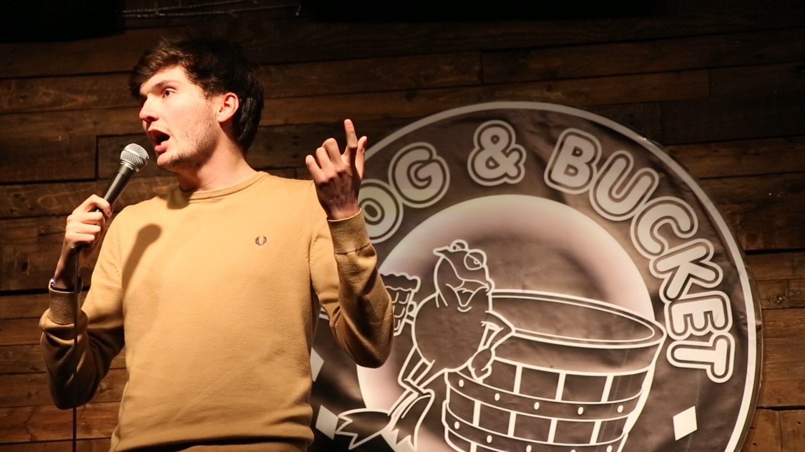 A photo of James Allen in a caramel top performing at the Frog and Bucket