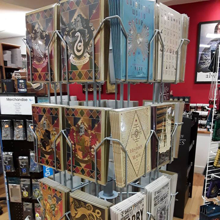A card display in the Hoot store that shows several different cards. The ones facing the camera are decorated with official Harry Potter artwork including the House crests for Gryffindor, Hufflepuff, Ravenclaw and Slytherin. You can also see cards with the silhouette of Hogwarts on and one with 'Quidditch World Cup' on. 